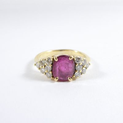 a yellow gold ring with a pink stone and white diamonds