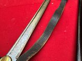 two different types of swords on a red cloth