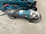 a drill and a box of tools on the floor