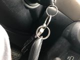 a car dashboard with a bunch of keys hanging from it ' s handle