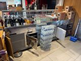 many bottles of water sitting on the counter in the store