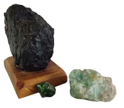 a rock that is sitting next to a rock on a wooden stand