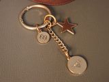 a keychain with a star and a star charm on it
