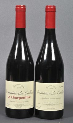 two bottles of red wine sitting next to each other on a table
