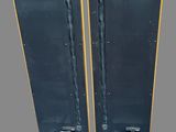two black speakers sitting side by side on top of a gray surface