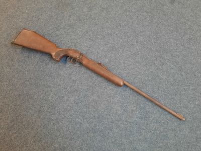 an old rifle with a wooden handle on a blue carpet