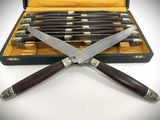 two knives in a case and a pair of knives in the case