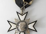 an image of a medal with a black and white ribbon around it