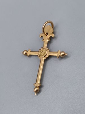 a close up of a cross on a table with a white background