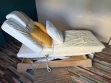 a bed that has two pillows on top of it