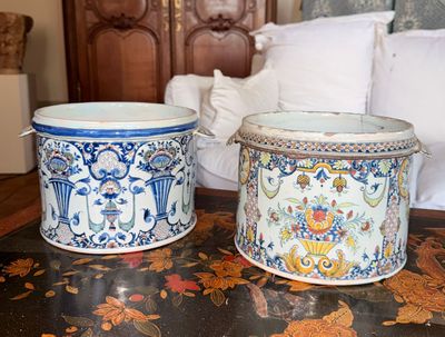 deux vases posés sur une table à côté d'un lit