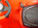a red toy car with a steering and a steering wheel
