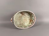 a white bowl with a red and green design on it