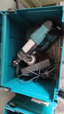 a blue box with tools inside of it on the floor