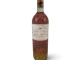 a bottle of wine that is sitting on a white surface