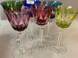 six wine glasses are lined up in a row on a table