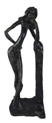 statue of a woman leaning on a rock with her hands on her hips