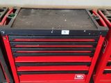 three red tool boxes are stacked on top of each other in a garage