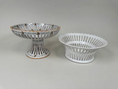 two white and gold decorated bowls and a bowl on a table