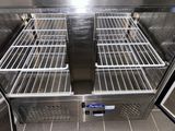 a stainless steel refrigerator with two shelves in the middle of it