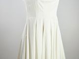 an image of a white dress on a mannequin stand