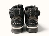 a pair of black and white shoes that are on a white surface