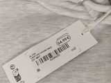 a close up of a white shirt with a tag on it