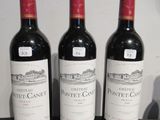 trois bouteilles de vin posées sur une table l'une à côté de l'autre