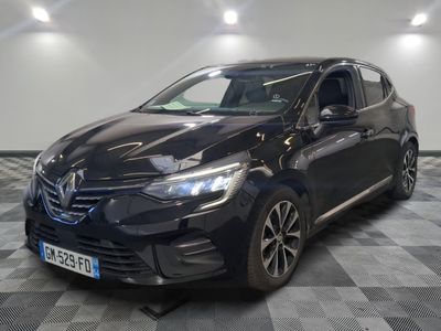 the black car is parked on a checkered floor in a garage