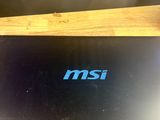 the laptop is sitting on the table with the msi logo on it