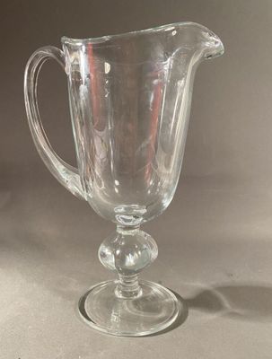 a glass pitcher sitting on top of a table