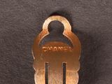 a metal key that is sitting on top of a black surface