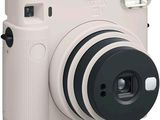 an image of a white camera with a flash light on top of it