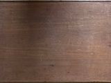 a cat that is sitting on a wooden table