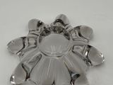 a silver plate with a flower on it on a table