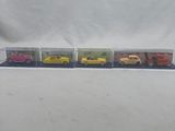 four toy cars that are lined up on a table