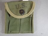 a small green pouch with a button on it