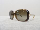 sunglasses on a white surface with a white wall in the background