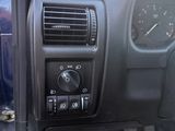 the dashboard of a car with a clock and radio in it