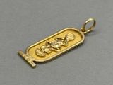 a close up of a gold plated pendant with an image of a man and a woman