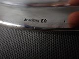 a close up of a silver plate on a table