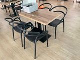 many chairs and tables in a restaurant with a cooler on the table