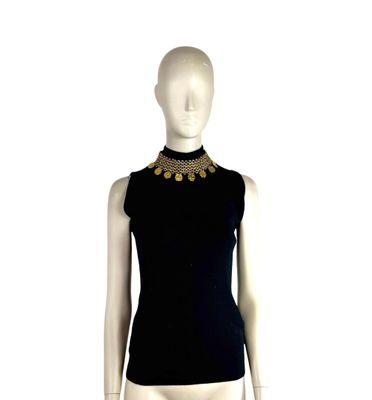 the mannequin is wearing a black top with a gold collar