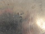 a close up of a metal plate with a hole in it