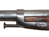 a close up of a gun with a wooden handle on a white background