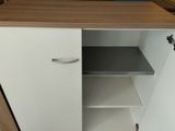 a white cupboard with a wooden top in a room
