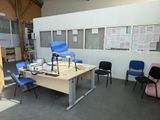 a room with several chairs and a table in it