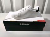 a close up of a white shoe on a box on a table