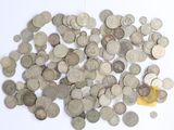 a pile of coins on a white surface with a yellow object