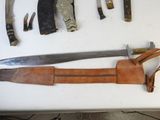 many different types of knives and knives on a table